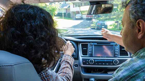 teenager and parent driving